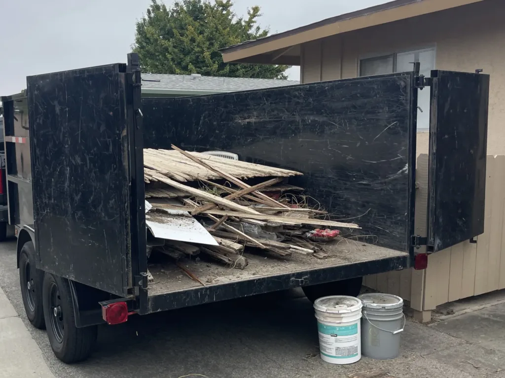 Old Fence Removal Wood Fence Debris in dump trailer
