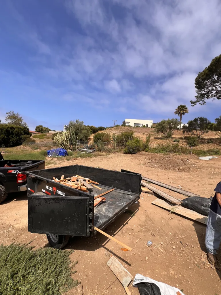 6x10 dump trailer being loaded with construction debris during a Malibu home cleanup project