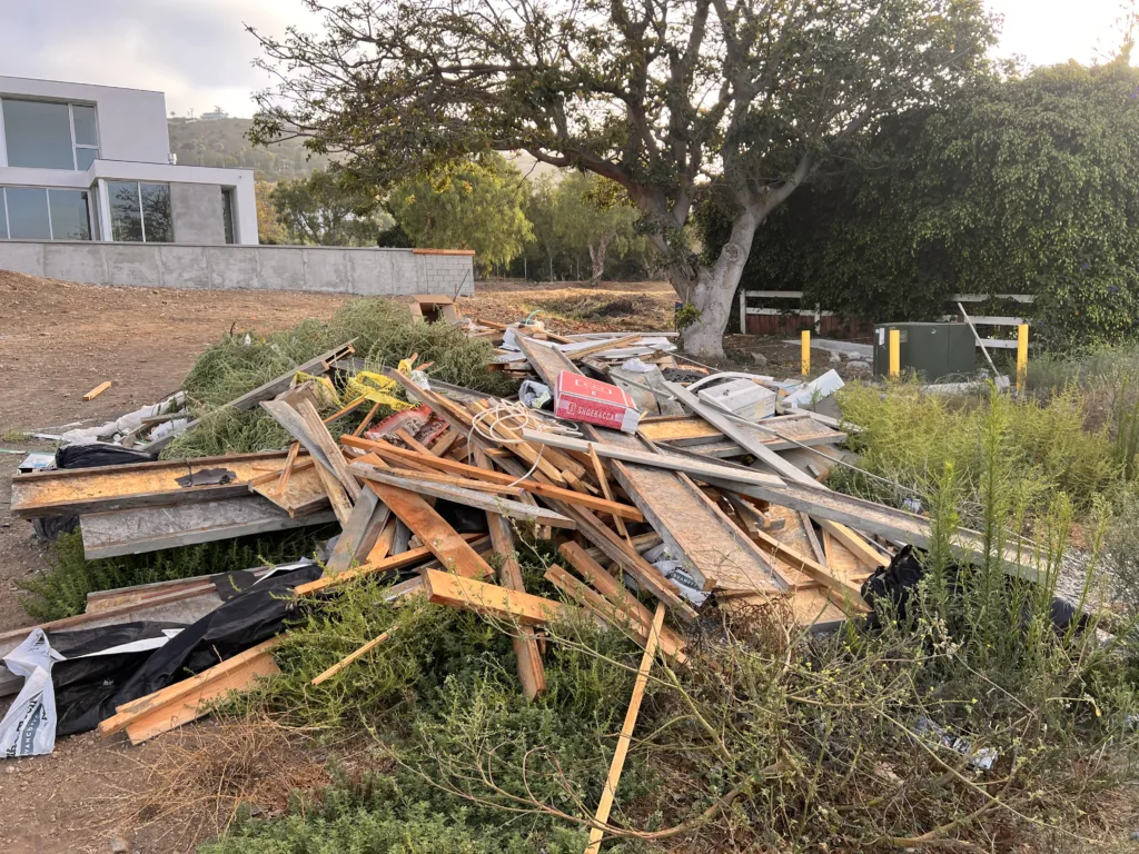 Construction debris pile outside a luxury home under construction in Malibu California
